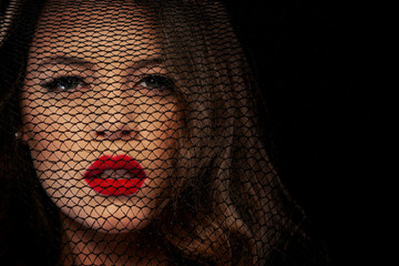 Woman behind black veil