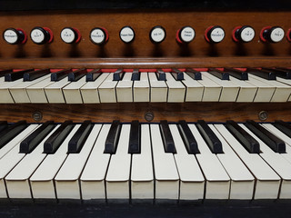Fototapeta na wymiar Old vintage wooden harmonium / pipe organ keyboard detailed close-up, frontal shot