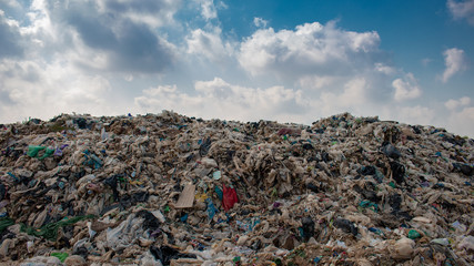 big garbage mountain with blue sky background