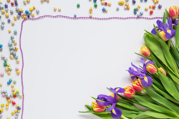 Fototapeta premium Frame made of flowers and stars on a white background