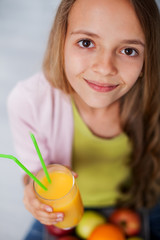 Young teenager girl with a glass of fresh fruit juice