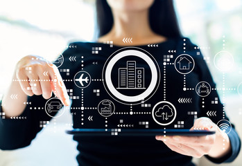 Smart city concept with woman using her tablet