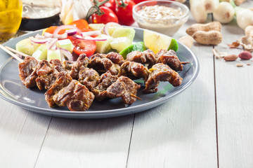 Traditional pork satay with peanut sauce and vegetables