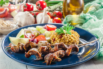 Traditional pork satay with peanut sauce and vegetables