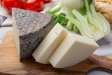 Italian cheeses, mature Tuscan Pecorino sheep cheese and Provolone dolce cow cheese served with olive bread and tomatoes