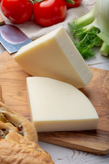 Italian cheese, Provolone dolce cow cheese from Cremona served with olive bread and tomatoes