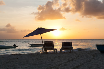 two beach  bed at sunset on the Worthing beach in Barbados. Carrivean sea.