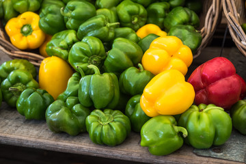 Green, red and yellow bell peppers at the market