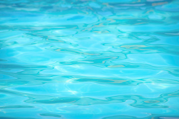 The blue water waves by wind and sunlight reflecting surface