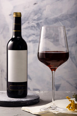 Red wine in a glass and a bottle on the table.
