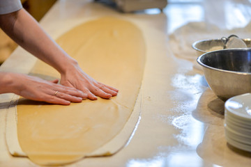 hands of baker kneading dough