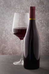 Red wine in a glass and a bottle on the table.