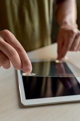 Fototapeta na wymiar man installing a screen protector in a tablet