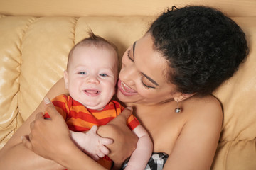 Pretty woman holding a baby in her arms
