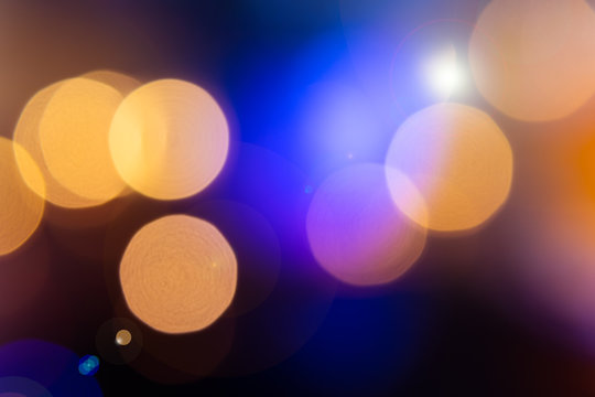 Colourful nightclub blurred bokeh background with blue pink and red tints from disco lights