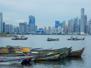 Fototapeta na wymiar Panama city skyline in a cloudy day with fishing boats moored in the bay, Panama, Central America