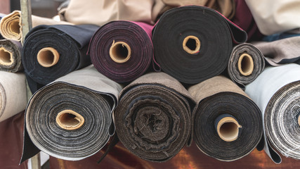 Different colored and textured fabrics for sale on a flea market