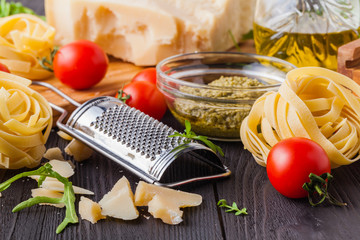 Ingredients ready for cooking delicious italian dinner for two: pasta, garlic, cherry tomatoes, red and green pepper, cheese
