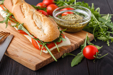 Close up of freshly made sandwich on wooden cutting board