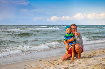 Dad and son on the beach - sunset on the Baltic Sea