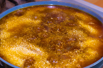 Preparation of Uzbek pilaf - evaporation of water from rice, close up