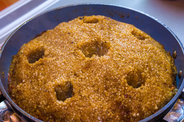 Preparation of Uzbek pilaf - evaporation of water from rice, close up