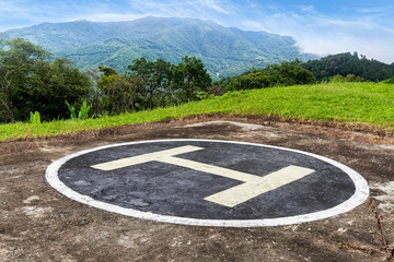 Heliport on peak of mountain with blue sky