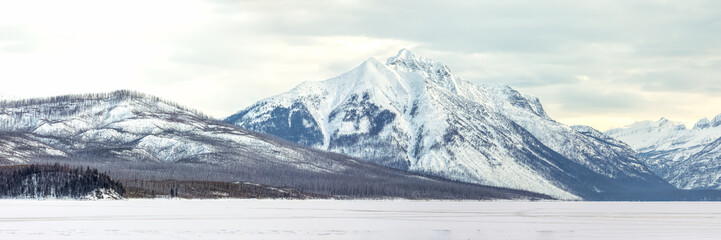 Snow covered mountains panorama overlooking Lake McDonald, Glacier National Park, Montana in winter