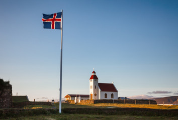 Waving flag of Iceland at white church Modrudalur farm Eastern Iceland Scandinavia