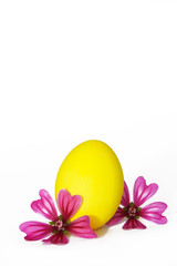 decorative yellow egg on green leaves for the holiday of holy Easter
