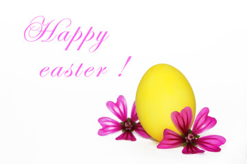 decorative yellow egg on green leaves for the holiday of holy Easter