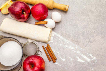 Apple pie ingredients baking concept. Fresh apples with cinnamon, flour, sugar, eggs. Cooking...
