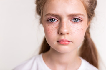 Naklejka premium Sad and upset little girl having teardrop on her cheek
