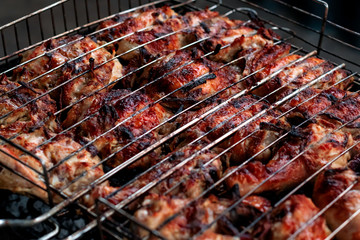 Grilled chicken steak on barbecue grill. Meat on fire.