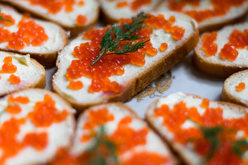 Sandwiches with red caviar and dill