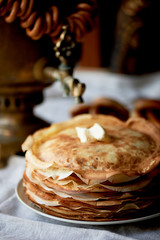A stack of pancakes with a melting piece of butter.Russian tea party
