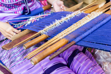 Thai Old women are using the machine - Household Loom weaving is Household occupation - for homemade silk or textile production of Thailand 