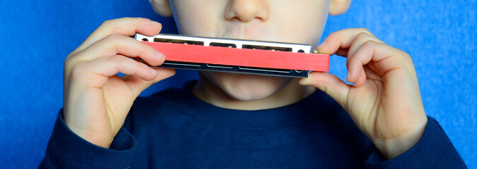 child playing the harmonica