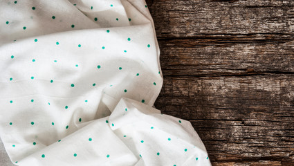 colorful tablecloth on wooden table. Top view