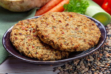 Tasty vegetarian food, raw burgers made from lentils legumes with vegetables ready for cooking