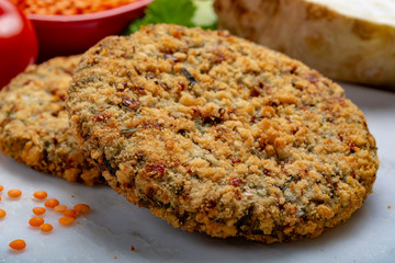 Tasty vegetarian food, raw burgers made from lentils legumes with vegetables ready for cooking