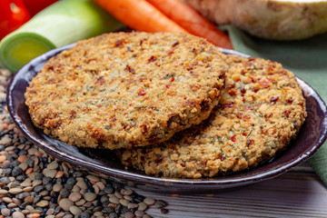 Tasty vegetarian food, raw burgers made from lentils legumes with vegetables ready for cooking