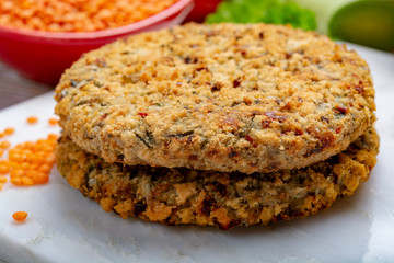 Tasty vegetarian food, raw burgers made from lentils legumes with vegetables ready for cooking