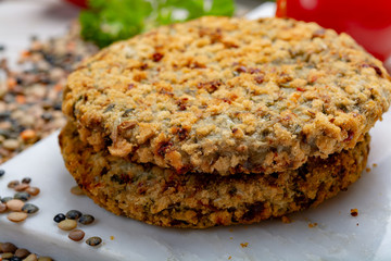 Tasty vegetarian food, raw burgers made from lentils legumes with vegetables ready for cooking