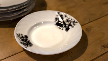 A vintage white porcelain  plate over the wooden table