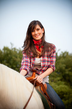 Young Woman Cowgirl Riding White Horse Outside