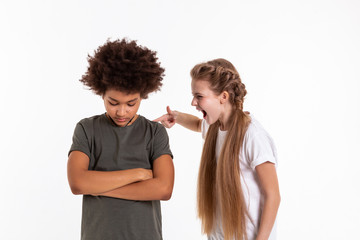 Crazy expressive little girl touching her wilted dark-haired friend