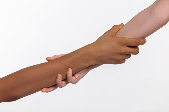 Children different hands tightly grabbing each other near the elbow