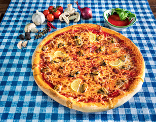 Seafood pizza with cheese and lemon