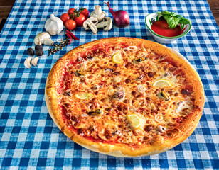 Seafood pizza with cheese and lemon